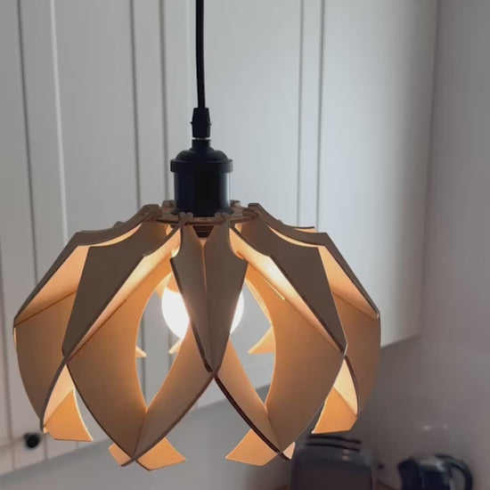 Short video showcasing different views of handcrafted small wooden pendant lamps with a modern flower-like design, highlighting the intricate craftsmanship, eco-friendly materials, and the beautiful light patterns they create.